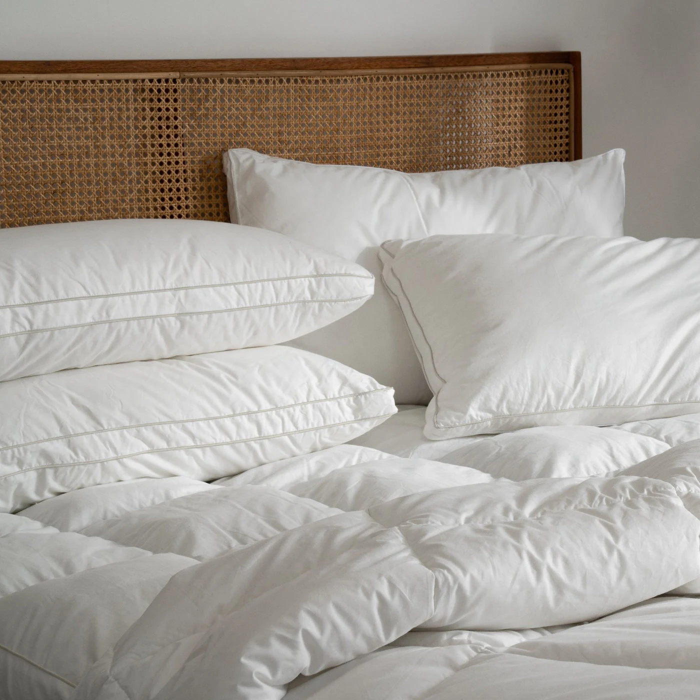 A freshly made bed with Suite Supply Co. pillows
